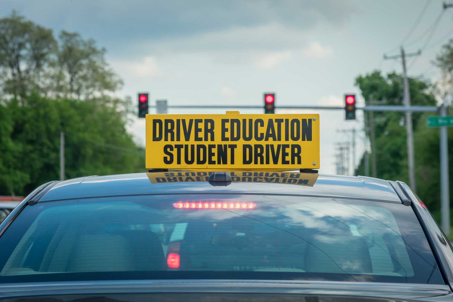 Student driver behind the wheel with a Rafael Driving School instructor
