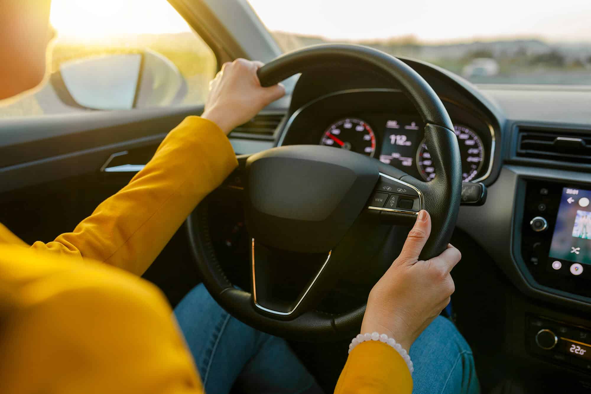 Hands on a steering wheel during a lesson