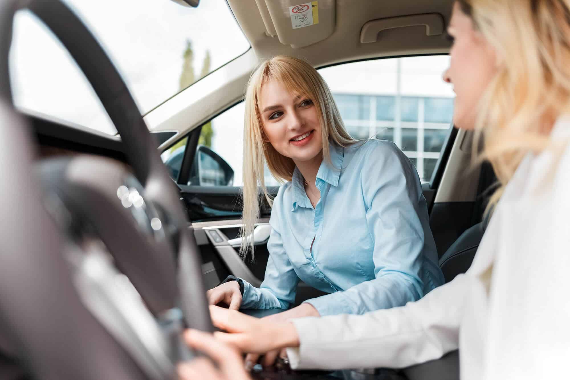New driver behind the wheel with an instructor in the passenger seat