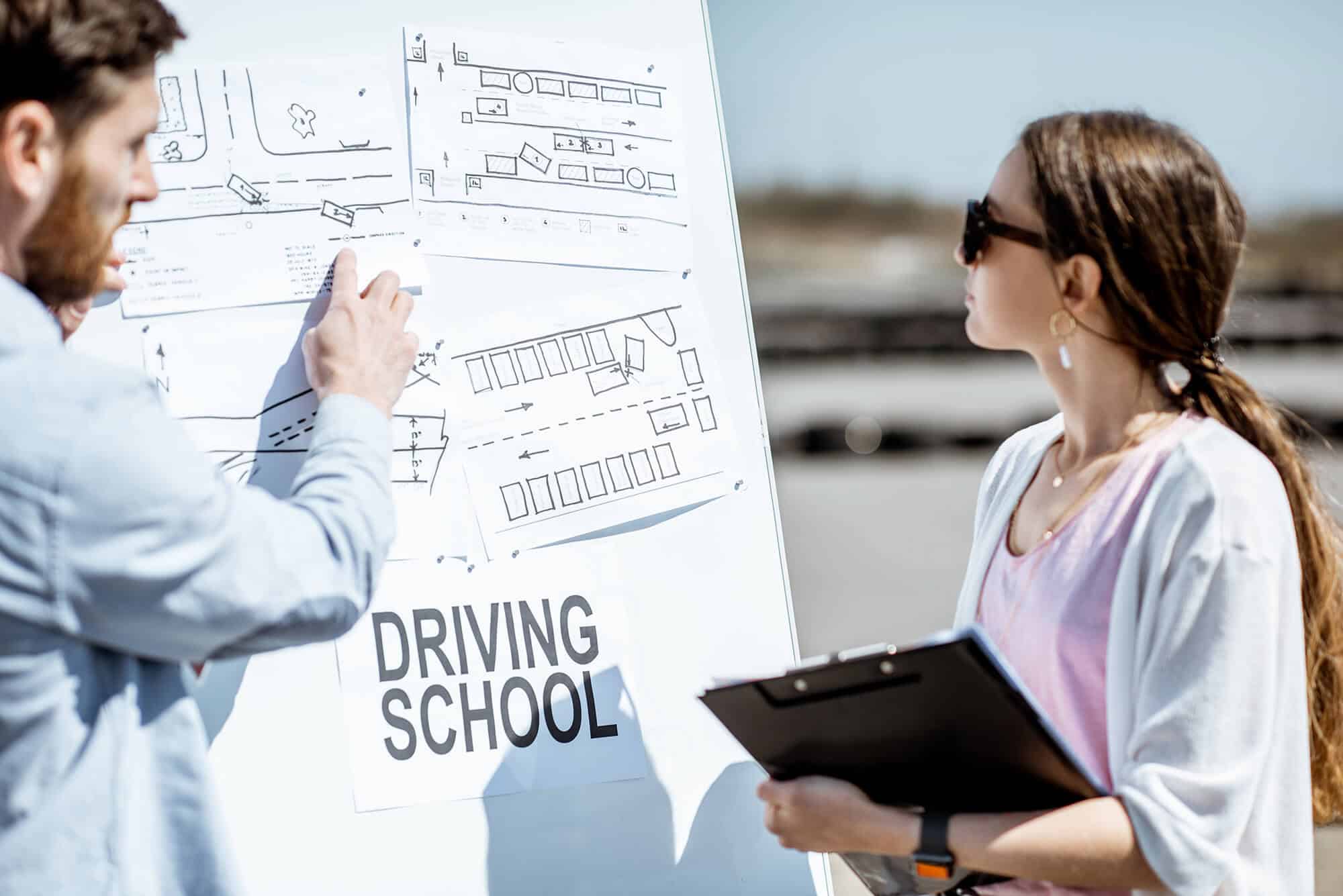 Instructor teaching traffic rules to a student at Rafael Driving School