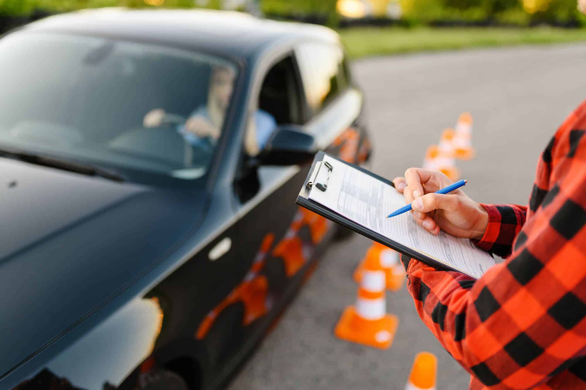 Instructor with a checklist guiding a student driver